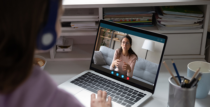 A person participating in a virtual mentoring session on a laptop, symbolizing online engagement and knowledge sharing.